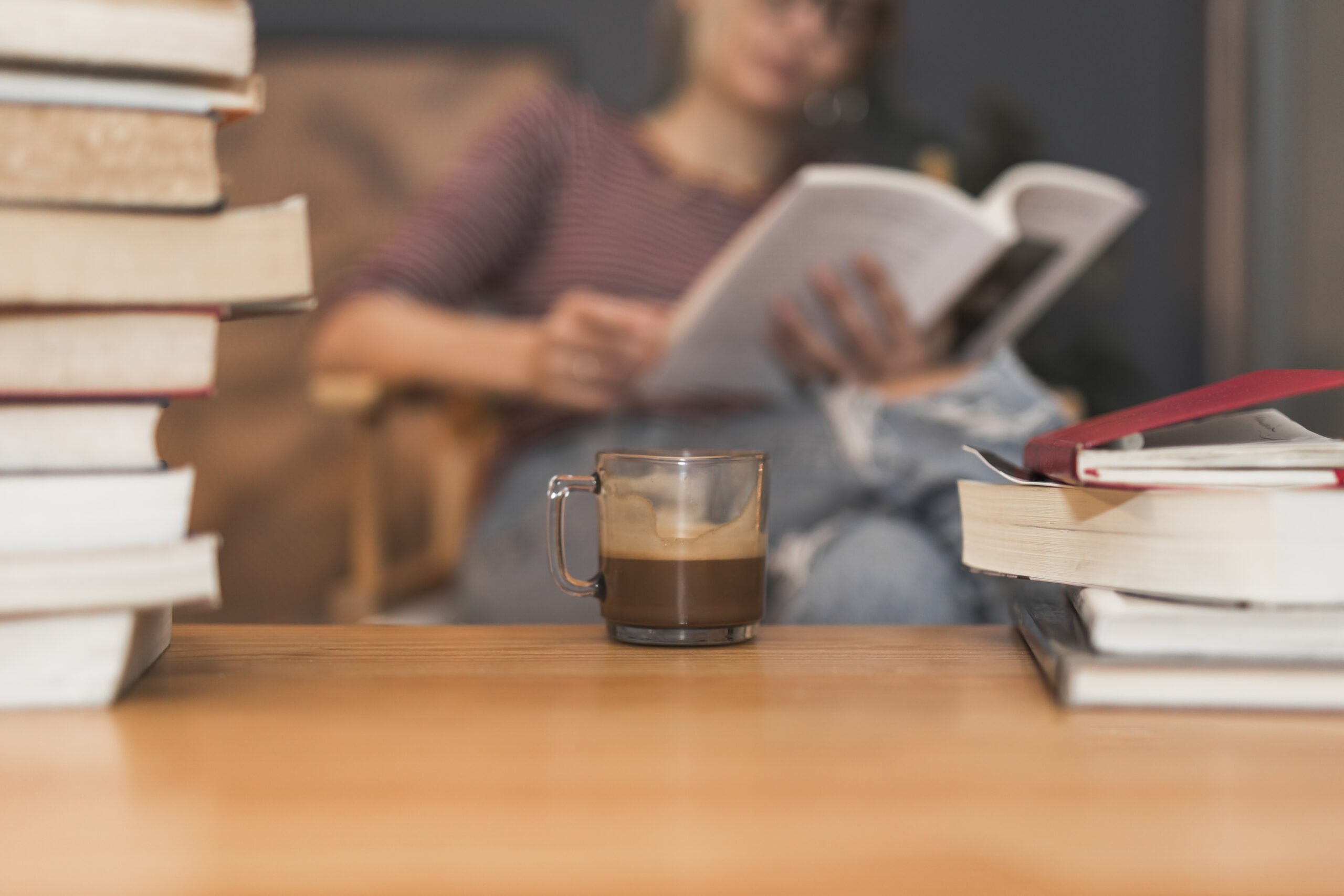 coffee-books-near-reading-woman